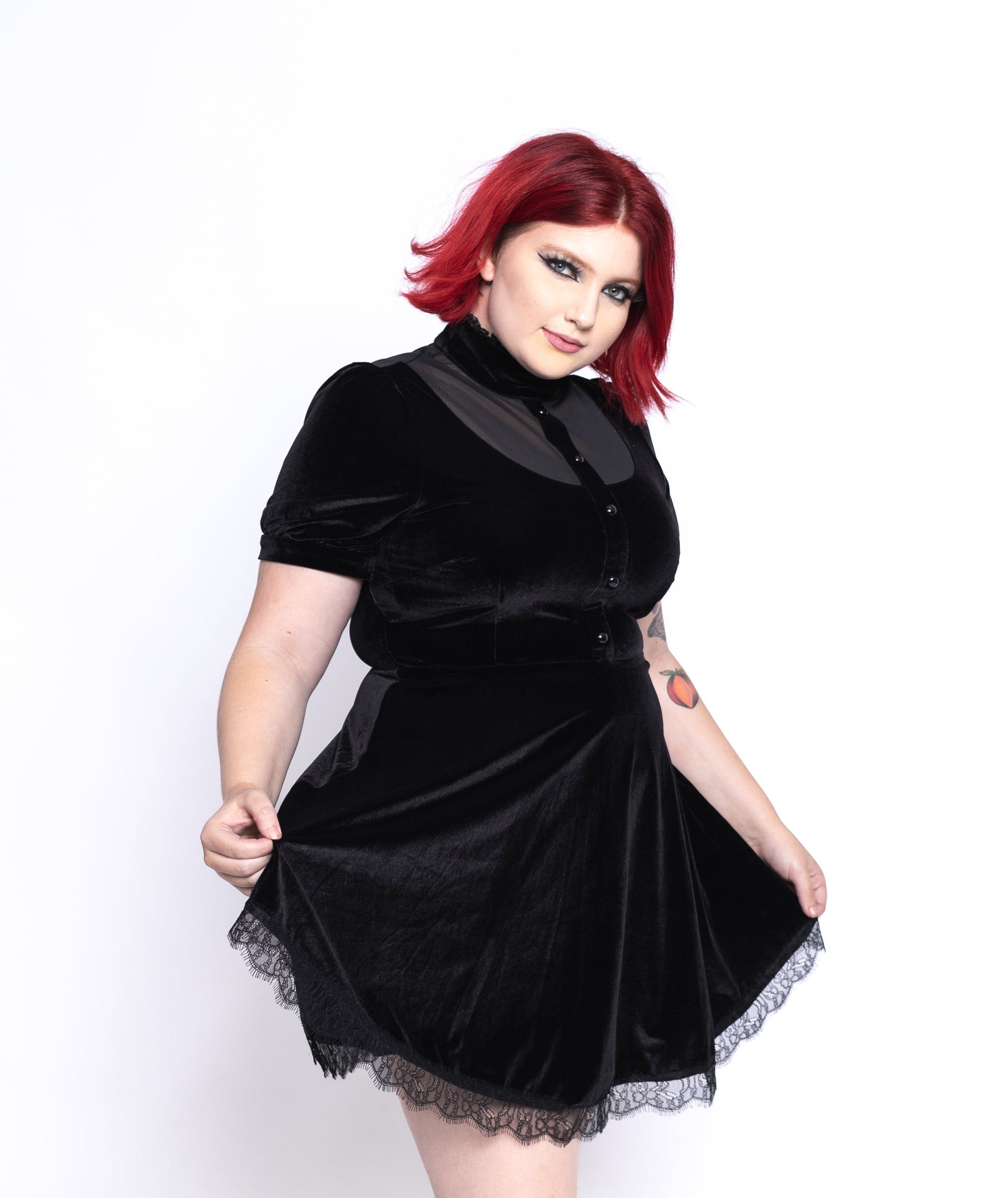 Black short sleeve gothic dress for women with lace trim worn by model with red hair