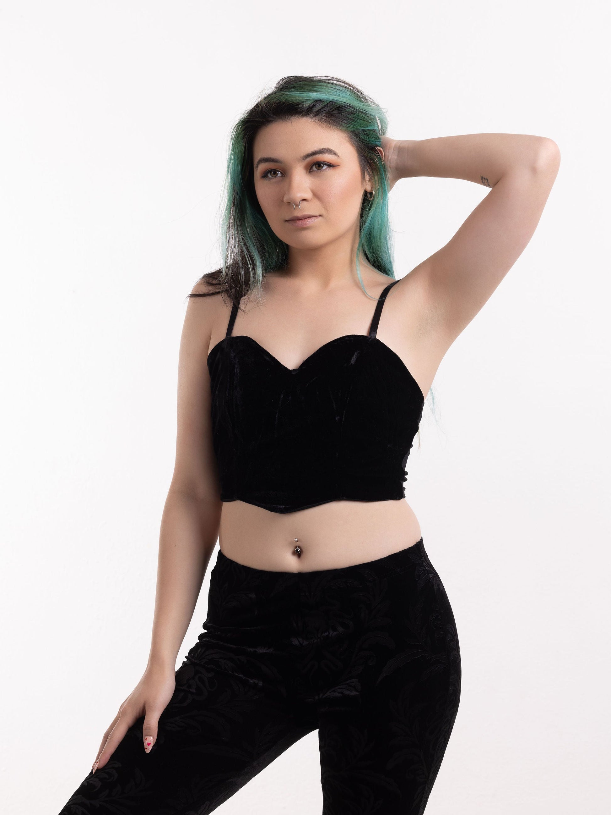 Woman wearing black gothic velvet cami with thin straps paired with matching velvet pants